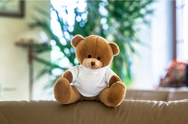 Light-brown teddy bear with a white T-shirt suitable for printing